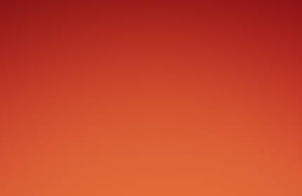 A close-up of three red lipsticks with gold packaging against a gradient orange background.