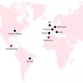 A world map highlighting locations where CARE International operates, marked with black dots for local initiatives and an orange logo designating CARE International, including countries like the United States, Guatemala, Brazil, Morocco, the UK, Germany, France, Spain, Italy, and Thailand.
