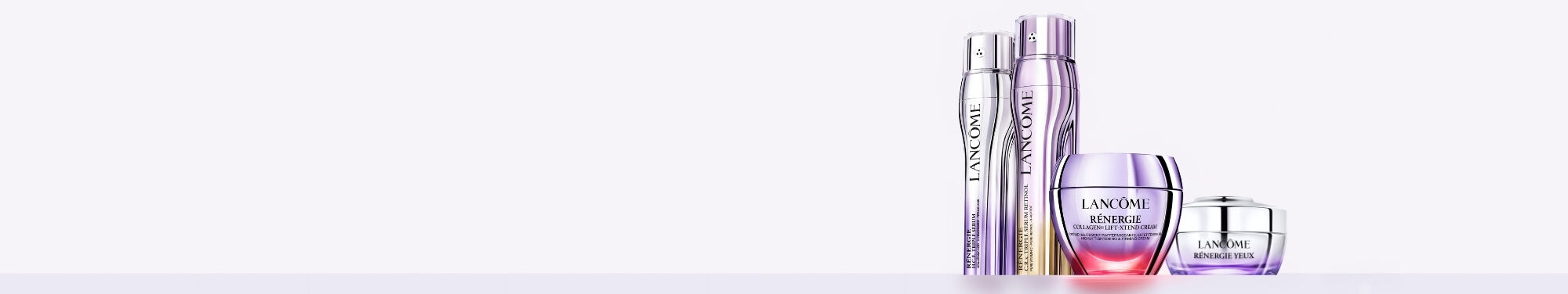 A promotional image featuring two Lancome skincare products against a soft purple background.