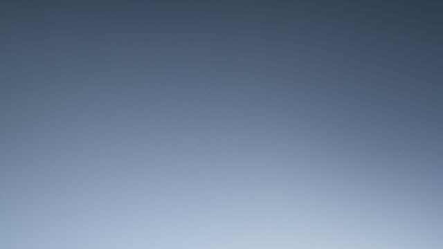 A collection of Lancome skincare products displayed elegantly on podiums against a dark starry background.