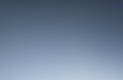 A collection of Lancome skincare products displayed elegantly on podiums against a dark starry background.