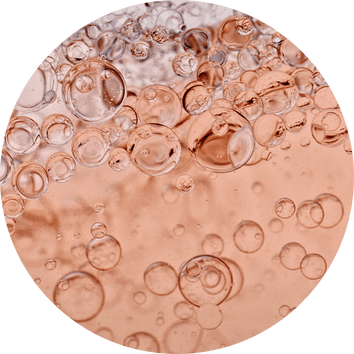 Bubbles rising in a sparkling, rose-colored liquid, creating a vibrant, effervescent texture.