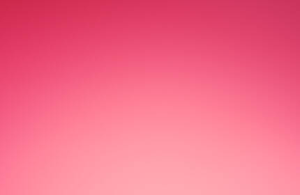 A vibrant pink background featuring a luxurious red gift box with a satin ribbon, showcasing the Lancome Paris logo on the top.