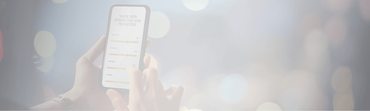 A person holding a smartphone displaying a screen with a chart titled "Your Skin Strengths and Priorities," showing various skin metrics with colorful bars. Blurred lights in the background create a soft, bokeh effect.