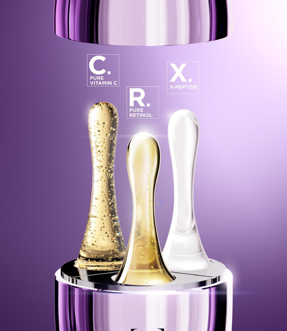 An image featuring three skincare serum bottles labeled with ingredients: "C. Pure Vitamin C" in a gold-colored bottle, "R. Pure Retinol" in a golden-brown bottle, and "X. X-Peptide" in a clear bottle, all set against a purple background.