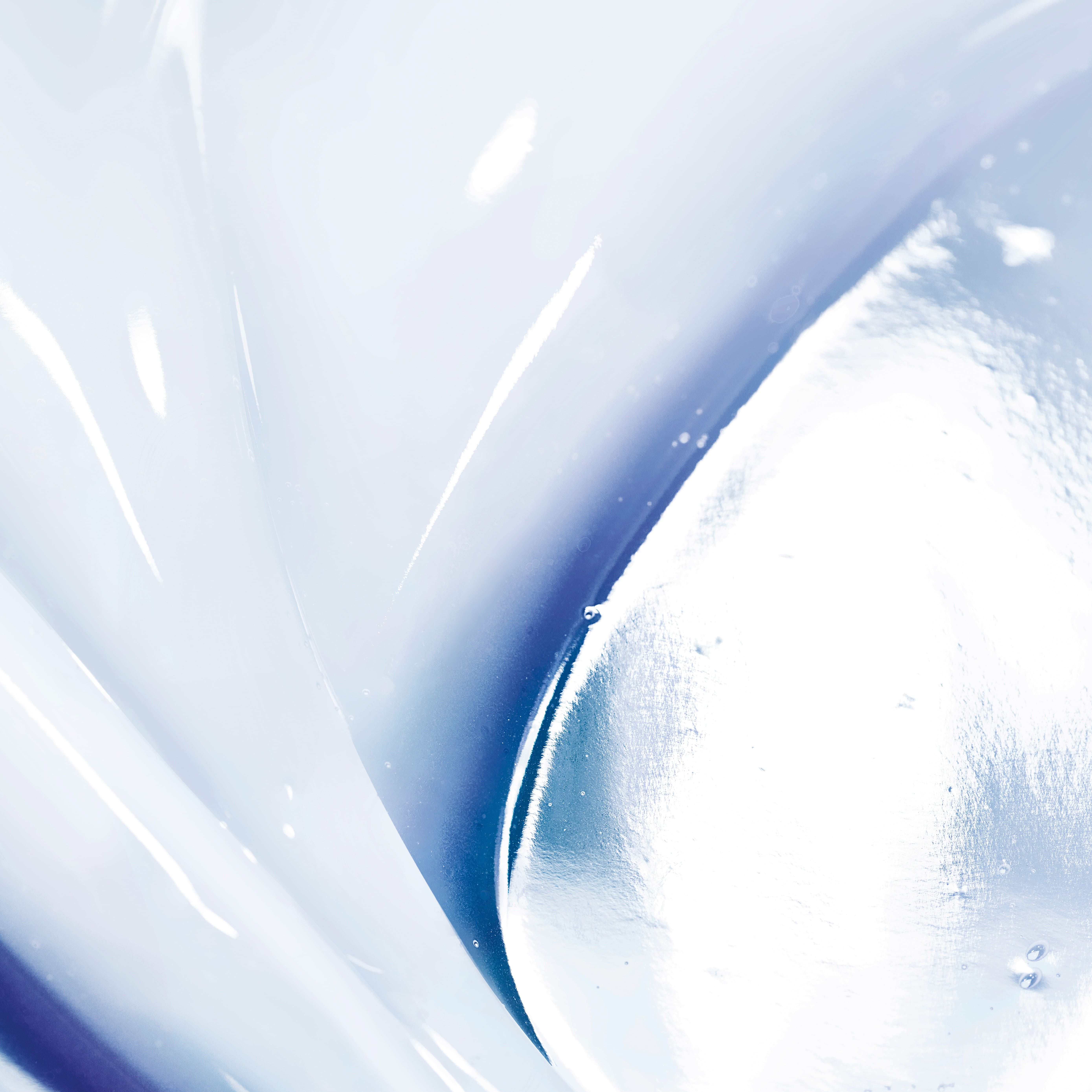Abstract close-up image featuring smooth, flowing textures in shades of blue and white, creating a fluid and serene appearance.