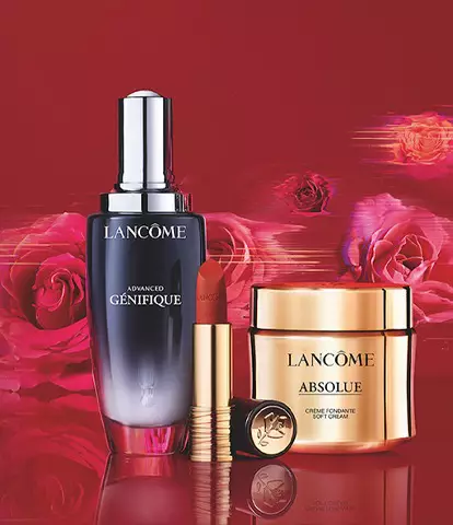 A stylish display of Lancome skincare products, including a serum, cream, and compact, set against a vibrant red background with roses.