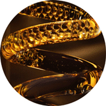 Close-up of a spiral glass sculpture with a golden hue, showcasing its textured surface and light reflections.