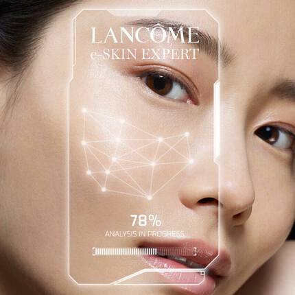 A woman examines her reflection with digital skin analysis graphics displayed beside her, showcasing skincare products and personalized results.