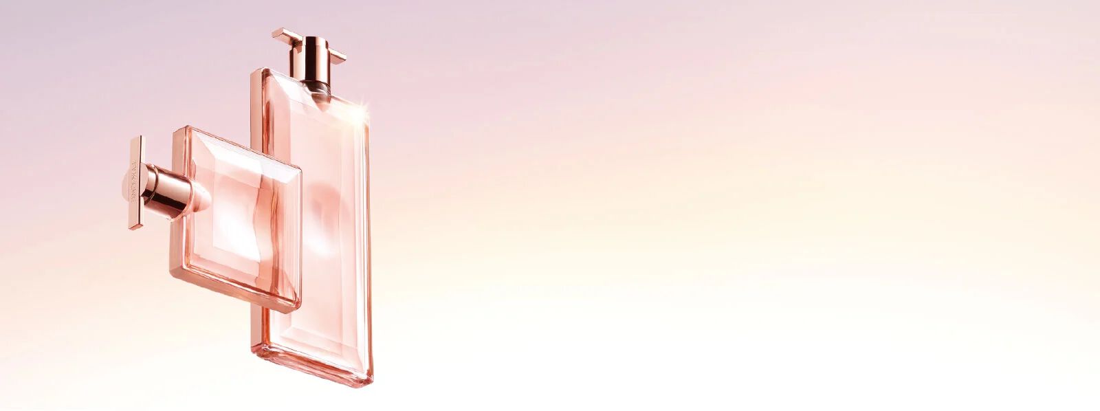 Two elegant perfume bottles in soft pink hues, set against a gradient background that transitions from light pink to a soft peach.