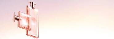Two elegant perfume bottles in soft pink hues, set against a gradient background that transitions from light pink to a soft peach.