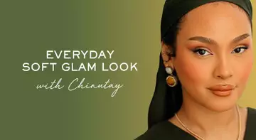 A portrait of a woman showcasing an everyday soft glam makeup look, wearing statement earrings and a headscarf, against a green background with text that reads "Everyday Soft Glam Look with Chriantay."