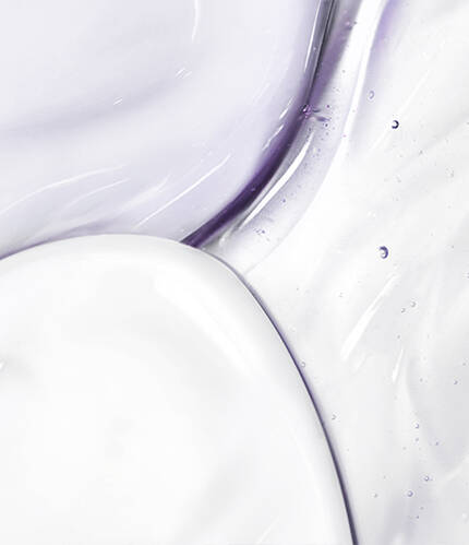 Abstract close-up of smooth, glossy textures in shades of white and light lavender, with droplets and subtle swirls.